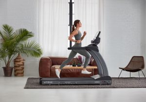 Woman running on a TRUE treadmill. Choosing The Right Treadmill For Your Home.
