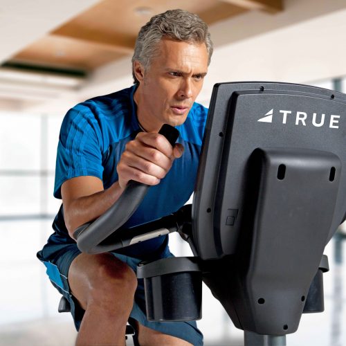 Older man working out on an indoor cycling bike