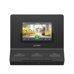 A black fitness machine console with a touchscreen displaying a nature running trail, exercise options, and buttons for quick start, user login, and settings. The brand TRUE is shown below the screen.