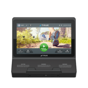 A digital treadmill console displaying a touch screen with exercise options, including a large Quick Start button and an image of a runners legs on an outdoor trail. The console is branded TRUE.