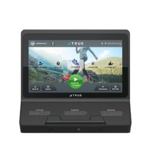 A close-up of a fitness machine touchscreen display showing workout options, a user profile area, and mountains in the background, with buttons labeled Program, Interval, Vision Run, Fitness Test, and Quick Start.